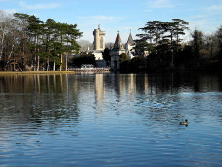 Laxenburg, Austria - January 02, 2022: Castle pond with a walkway for visitors to Franzensburg Castle with reflection in the lake, a small ferry operates in the warmer months. The public park is a preferred destination near Viennaのeditorial素材