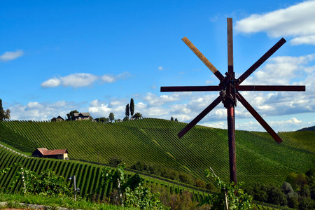Austria, traditional Klapotez scarecrow and vineyards on the steep slopes located on the Styrian...