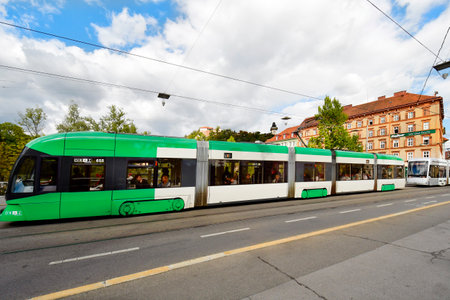 Graz, Austria - September 22, 2022: Tram as public transport on Archduke Johann Bridge with Castle hill and glock tower - clock tower in backgroundのeditorial素材