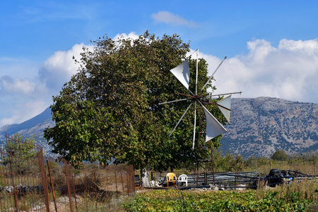Greece, Crete, the Lasithi plateau is mainly used for agriculture, the traditional wind turbines were used in an environmentally friendly way to obtain waterの写真素材