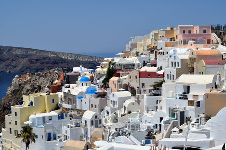Oia, Santorini, Greece - June 22, 2022: View of the town of Oia, the nestled white houses are built on the cliffs overlooking the calderaのeditorial素材