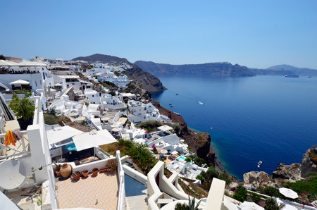 Oia, Santorini, Greece - June 22, 2022: View of the town of Oia, the white houses are built on the cliffs overlooking the calderaのeditorial素材
