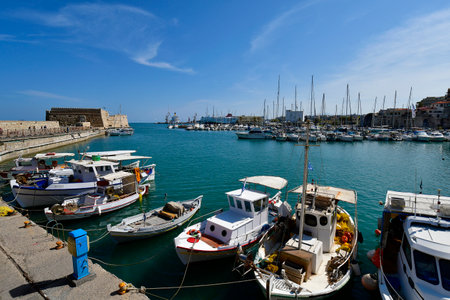 Heraklion, Greece - October 14, 2022: The capital of Crete Island, the small harbor for yachts and fishing boats with the Venetian Fortress Koules and old Venetian dockyardsのeditorial素材