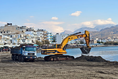Ierapatra, Crete, Greece - October 12, 2022: Excavators and trucks during excavation work at the port of Europe's southernmost city on the Libyan Seaのeditorial素材