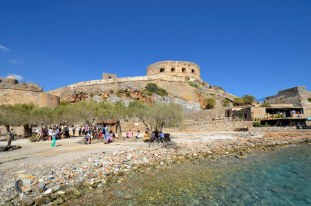 Plaka, Crete, Greece - October 10, 2022: Unidentified tourists to old Venetian Fortress Spinalonga, formerly used as a leper station, now a popular tourist destinationのeditorial素材