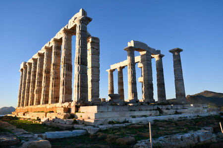 Lavrio, Greece - December 19, 2023: The ancient Temple of Poseidon in the light of the setting sunの写真素材