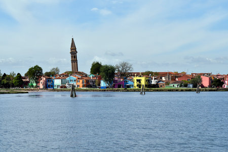 Burano, Italy - View of the colorful houses, the historic water tower and the church Chiesa Parrocchiale di San Martino Vescovo with the leaning steeple on the island of Burano in the Venice lagoonの写真素材