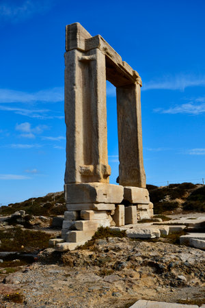 Naxos, Greece - September 20, 2024: the Temple of Apollo â Portara, a huge marble gate on a peninsula reachable over a causeway near the harborの写真素材
