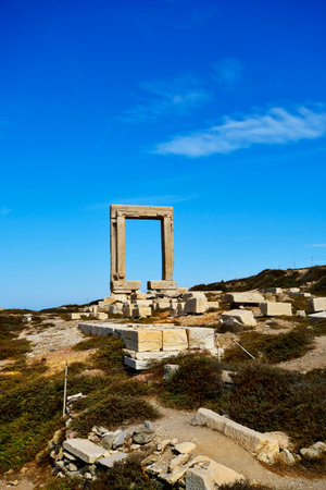 Naxos, Greece - September 20, 2024: Unidentified tourists at the Temple of Apollo â Portara, a huge marble gate on a peninsula reachable over a causeway from the harborの写真素材