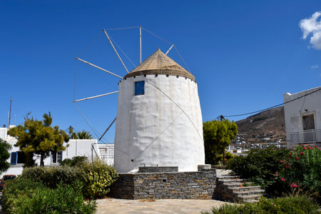 Greece, old windmill on Anna Hill on the Cycladic Island Paros with view to Parikia Townの写真素材