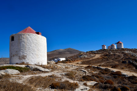 Greece - Medieval windmills, chapel and water tanks on the hill in Chora, Amorgos Islandの写真素材