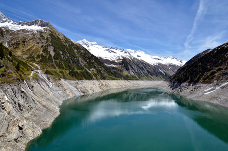 Mayrhofen, Austria - Stillup reservoir with wonderful views of the Zillertal Alps in the Hohe Tauern massif and hiking trail along the lake to the so-called Little Tibet rest areaの写真素材