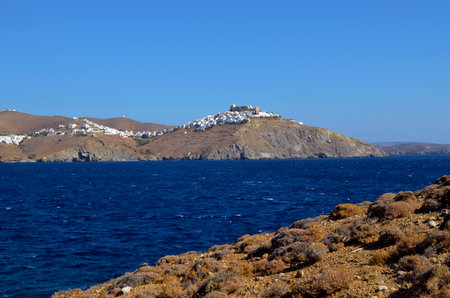 Astypalea, Greece - September 07, 2025: View from Agios Konstantinos beach over Livadi bay to Chora town with old castle and windmills on the island in the Aegean Seaの写真素材