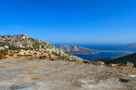 Goats grazing on the barren land, overlooking small uninhabited islands in the Aegean Seaの写真素材