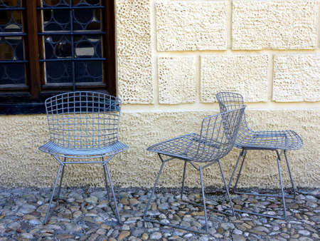 three chairs in a yard before a windowの写真素材