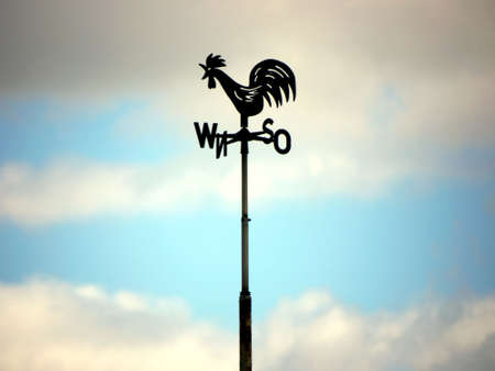 Weather-cock before cloudy skyの写真素材