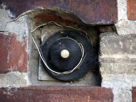 Bell and wire on old brick wallの写真素材