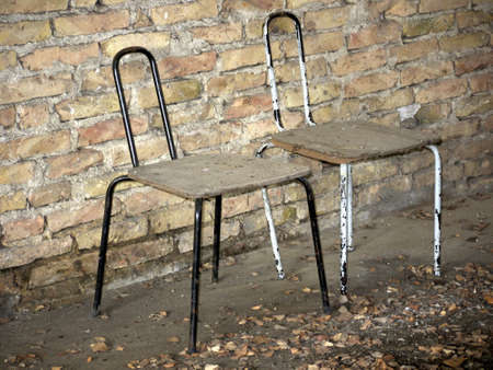 two chairs in front of a brick wallの写真素材