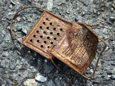 rusty grater on stone floorの写真素材