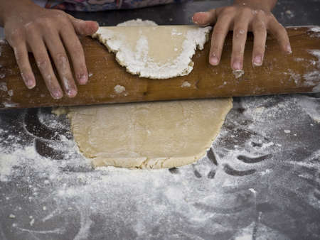 Dough is rolled with a rolling pinの写真素材