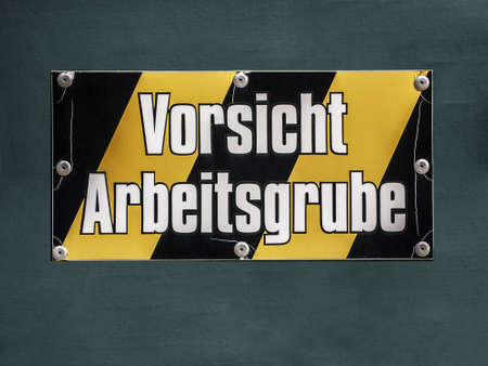 Sign in yellow and black; Caution working pitの写真素材