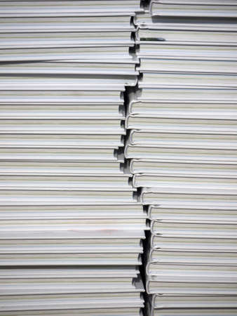 stack of white books in front of a shopの写真素材
