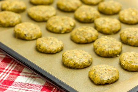Dough products for oatmeal cookies with chia seeds on a baking trayの写真素材