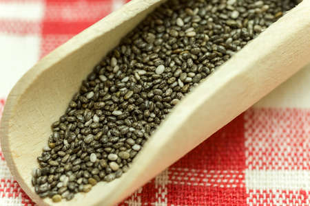 Chia seeds in a wooden spoon - Chia is a plant from Mexico and it is considered very healthy. The seeds contain a high percentage of omega-3 fatty acids, vitamins, antioxidants, proteins and minerals. Chia seeds swell considerably on and are suitable for の写真素材