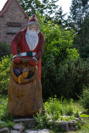 Furstenberg, Himmelpfort, Oberhavel, Brandenburg, Germany - Here is the Christmas Post Office, where will be answered in the time of Advent Wishlist of children from around the world - Santa Claus figure in front of a houseのeditorial素材