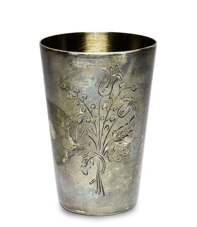 A old silver cup engraved with a picture of a flowerの写真素材