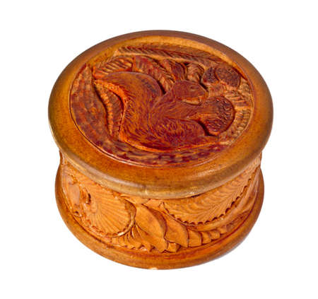 Round wooden box decorated with carvings. Squirrel with pine cones.の写真素材