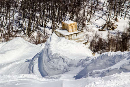 Defenses in the mountains  Stone cones for mitigating the avalanche  Anti avalanche dam in the backgroundの写真素材