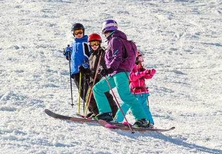 Group of children on a ski slope listens adult skierの写真素材