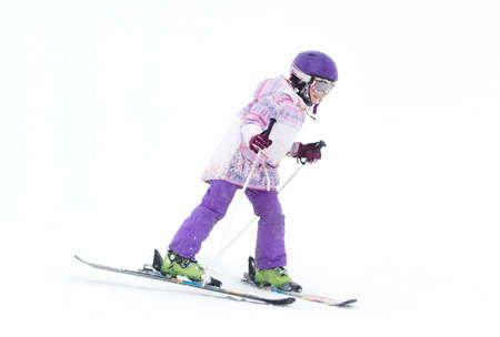 Little Girl on skis in the mountains in the fog looking for the roadの写真素材