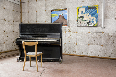 PYRAMIDEN, NORWAY - June 25, 2015: Inside of the ruined building (music room) at the abandoned Russian arctic settlement Pyramiden, Norway.のeditorial素材
