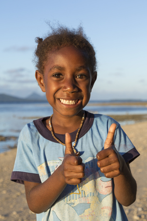 Tanna, Republic of Vanuatu, July 17th, 2014, Happy indigenous girl at the beach at sunsetのeditorial素材