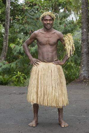 Tanna, Republic of Vanuatu, July 12th, 2014, Portrait of an indigenous man with traditional headdress and skirtのeditorial素材