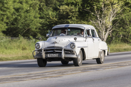 Cardenas, Cuba - November 26th, 2015: White vintage car (vintage car) in the streets of Cardena,...