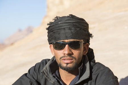 WADI RUM, JORDAN - 27 December 2015: Portrait of a handsome bedouin with black clothingのeditorial素材