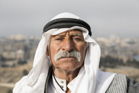 JERUSALEM, ISRAEL - December 16 2016: Arab man wave to peace against the Temple Mount and lift his...