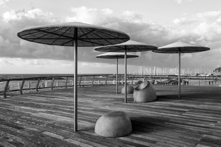 Modern beach promenade with umbrellas and relax seat in Tel Aviv, Israelの写真素材