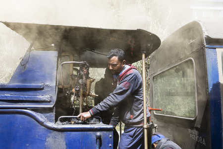Darjeeling, India, March 3 2017: The locomotive driver drives the famous steam locomotive toy train in Darjeelingのeditorial素材