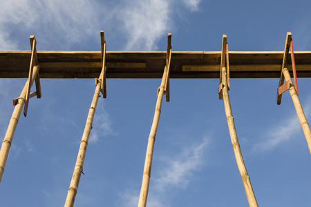 Bamboo scaffolding in structure building on blue sky in Darjeeling, Indiaの写真素材