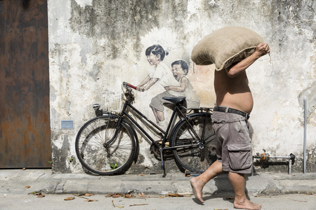 George Town, Penang, Malaysia, December 19 2017:: Little Children on a Bicycle street art mural by Lithuanian artist Ernest Zacharevic in Georgetown, Penang, Malaysiaのeditorial素材