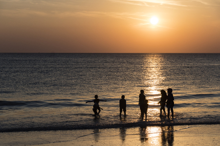 Langkawi, Malaysia, December 21 2017: Family bathes on Langkawi beach at sunsetのeditorial素材