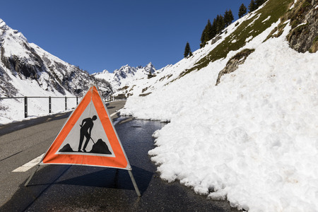 Warning sign because of a road blocked by a snow slide in the Alpsの写真素材