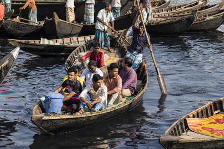 Dhaka, Bangladesh, February 24 2017: Passengers arrive in a wooden taxi boat at Sadarghat Terminal in Dhaka Bangladeshのeditorial素材