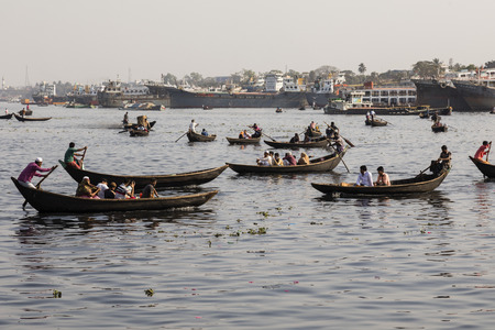 Dhaka, Bangladesh, February 24 2017: Small rowboats serve as taxi between the two river banks on the Buriganga River in Dhaka Bangladeshのeditorial素材