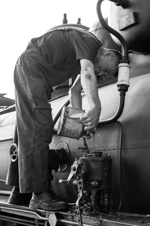 Sargan Vitasi, Serbia, July 17 2017: A train driver fills in oil. From here start the so calledのeditorial素材