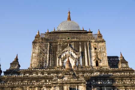 After an earthquake, a damaged old pagoda in Bagan is partially scaffolded with bamboo and the roof is covered with plastic wrap, Myanmarの写真素材